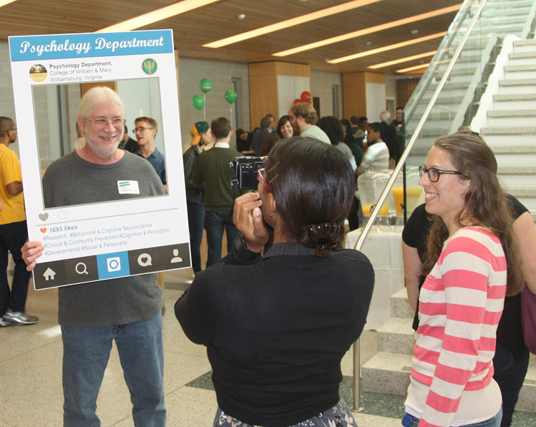Lauren Howard and Rachel Scrivano take a "selfie" of Professor Kirkpatrick during the Homecoming Open House
