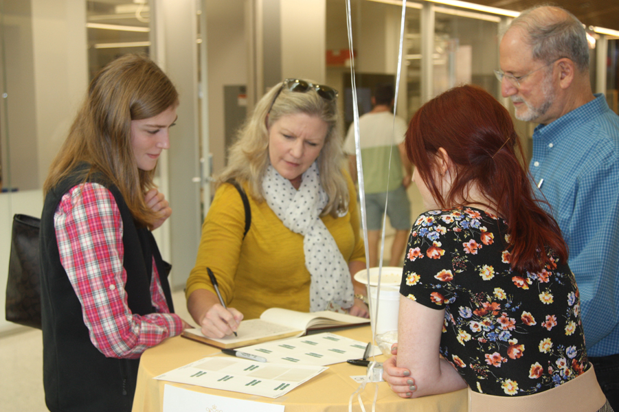 Michelle Bias (Class of 1988) and Emma Bias register during the Homecoming Open House 