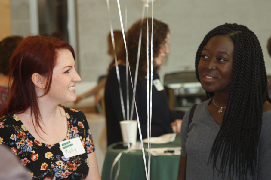 Molly Penrod (MA Class of 2018) greets Maku Orleans-Pobee (Class of 2017)