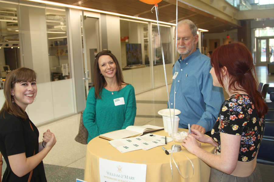 Natalie Libster (Class of 2016) shares a laugh with Professor Dallaire, while Professor Langholtz looks on during registration