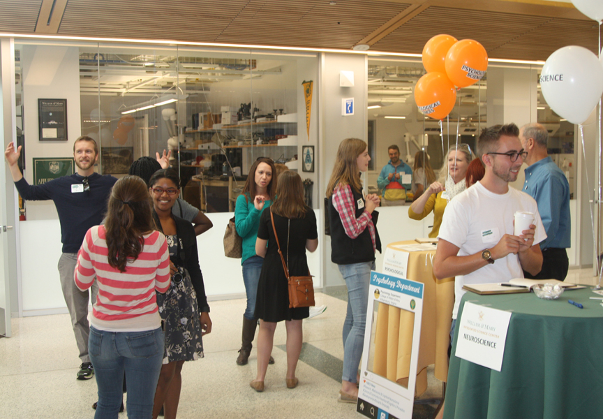 Faculty and friends in the atrium during the Homecoming Open House