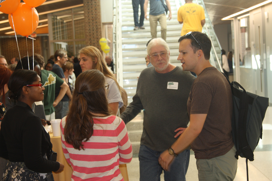 Faculty and friends in the atrium during the Homecoming Open House