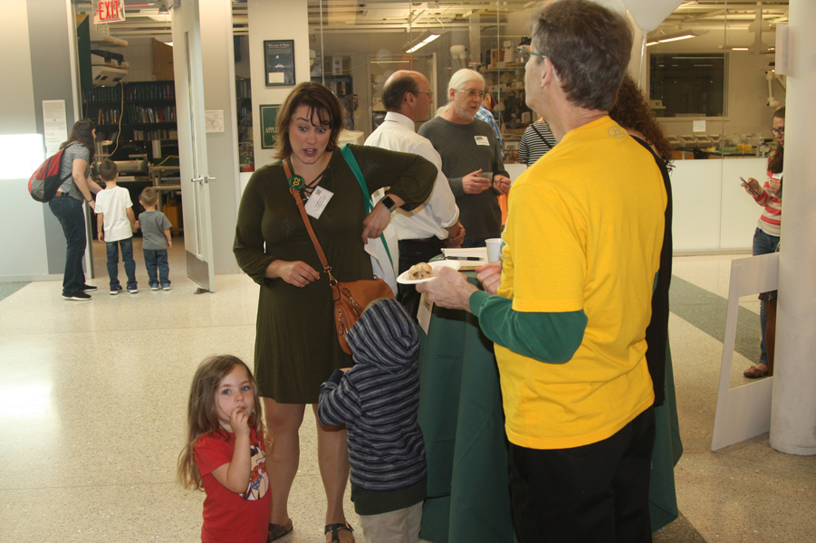 Faculty and friends in the atrium during the Homecoming Open House