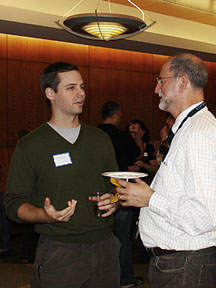 Andrew King '05 talking to Prof. Harvey Langholtz