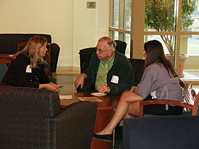 David Hitt '63 entertains Amanda Fuller '09 and staff member Claudia Smith (right)