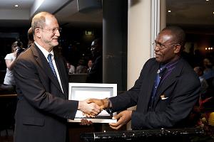 Professor Harvey Langholtz receiving the 2009 Peacekeeping Education and Training Award at the annual meeting of the International Association of Peacekeeping Training Centers, 26 November in Sydney, Australia. The award is being presented by Rear Admiral Gboribiogha Johah, Director of the Nigerian War College, and President of the International Association of Peacekeeping Training Centres.