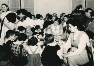 Female aid workers feed young children in the Bergen Belsen displaced persons camp. United States Holocaust Memorial Museum, courtesy of Elana Millman.