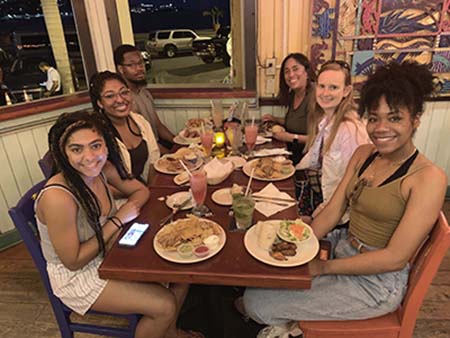 Enjoying the local cuisine (from left): Cassie Nestor '20, Alexandra Harris '21, Leke Robinson '21, Professor Osiapem, Brittany Young '20, and Daphney Edouard '20.