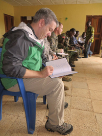 Patrick Flaherty ’92 records observations during a meeting with health officials in Margibi County, Liberia to select a site for an Ebola Treatment Unit (ETU). The Armed Forces of Liberia will lead the construction of several ETUs in Liberia.