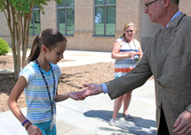 Mason gives his lapel pin to a student who complimented it.