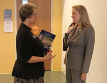 Pogge (right) talks with Matkins before visiting the camp.