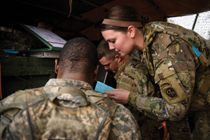 1st Lt. Emily Bessler '14, a platoon leader with the 82nd Division Artillery, talks about the M777 howitzer. (Photo by Andrew Craft for the Fayetteville Observer)