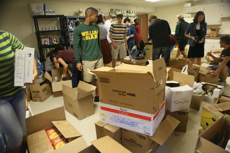 Students with the W&M Campus Kitchen organize the goods donated by the Black Law Students Association. (Photo by Stephen Salpukas)