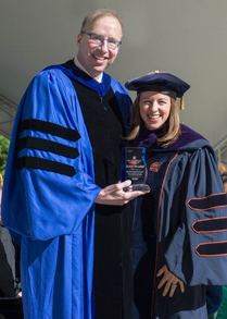 Associate Professor of Law Allison Orr Larsen '99 receives the award from Law Dean Davison M. Douglas.
