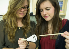 Jill Lineburg (left) and Erin Roberts discuss design of a model of a fish’s oral cavity used to examine fluid dynamics of a filter-feeding fish. Photo by Joseph McClain