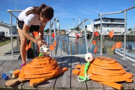 Bianca Santos readies the wooden/styrofoam models for deployment into Chesapeake Bay.
