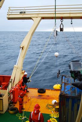 VIMS professor Elizabeth Shadwick and marine technician Olivia De Meo help deploy their mooring into the frigid waters of the Southern Ocean from the RV Laurence M Gould.