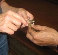 Raymond Bernard Bowman Sr. explains what one of the Wren Building keys is for as he hands them over to Susan Kern. (Photo by Jennifer L. Williams)