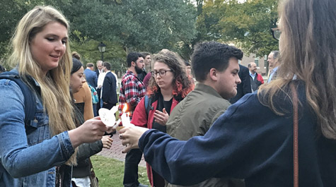 Students share the light of their candles before the vigil. (Photo by Erin Zagursky)