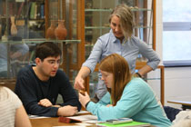 Professor Jessica Paga talks with students about their artifacts. (Photo by Stephen Salpukas)