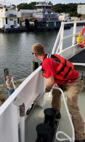 Mate Taylor Moore (right) deploys a docking line while marine safety officer Jim Goins assists. Home port for the R/V Virginia is the Ampro Shipyard on the Rappahannock River.