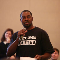 Ph.D. candidate Travis Harris reported his table's ideas as part of the conversation. (Photo by Stephen Salpukas)