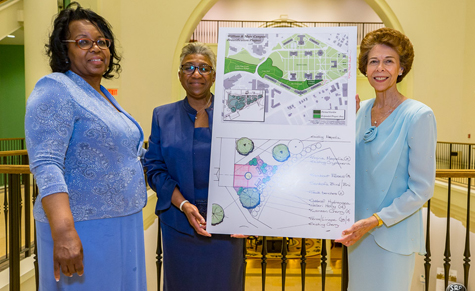 (From left) Ely, Briley and Strafer pose with a rendering of the garden. (Photo by Skip Rowland '83)