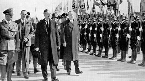 British Prime Minister Neville Chamberlain and Nazi Party leader Adolf Hitler meet in Munich in 1938.