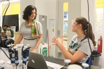 Rowe talks with a student in the Integrated Science Center. (Photo by Stephen Salpukas)