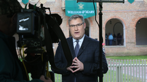 CNN reporter Mark Preston broadcasts near the Wren Building on Wednesday. (Photo by Stephen Salpukas)