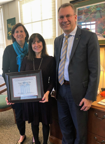 Mary Louise Gerdes (left) presents the certificate to Mane Pada and John Poma. (Courtesy photo) 