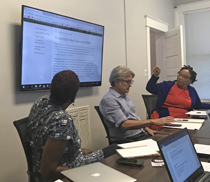 Phyllis Slade Martin (right) discusses the competition website during a meeting.