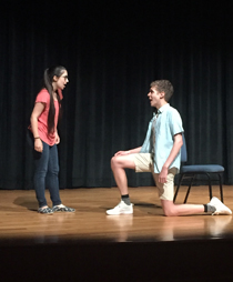 Pablo Solano '22 pops a serious question to Katy Shinas '22 in "The Wheel of Calamity." (Photo by Jo Rozycki '20)