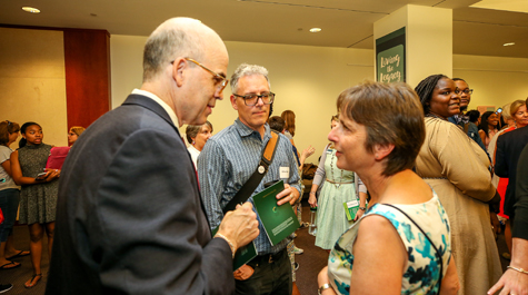 Halleran talks with English Department Chair and Chancellor Professor Suzanne Raitt at the unveiling of a mural to mark the 50th anniversary of W&M's first African-American students in residence. (Photo by Skip Rowland '83)