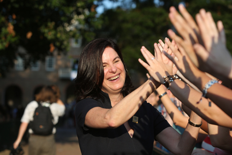 President Katherine A. Rowe high-fives students after the ceremony. (Photo by Stephen Salpukas)