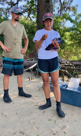 Field assistants Matt Oliver and Emelia Marshall prepare to measure water temperature and salinity at their sampling site for juvenile striped bass on the James River. (Photo by D. Malmquist/VIMS)