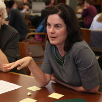 President Katherine A. Rowe talks with tablemates. (Photo by Collin Ginsburg)