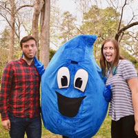 Kyle Parker '19 (left) and Megan Gillen '20 show their enthusiasm for Take Back the Tap mascot Droppy. (Photo by Carlyn LeGrant)