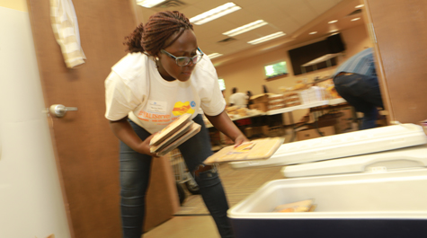 Nerima Were from Kenya helps sort supplies. (Photo by Stephen Salpukas)