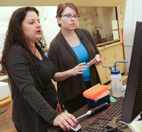 Helen Murphy examines data on yeast colonies with student Imanda Ivanoff. (Photo by Stephen Salpukas)