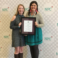 2017 president Mary Kate Maher (left) accepts an Excellence Award, accompanied by Anne Strickland.