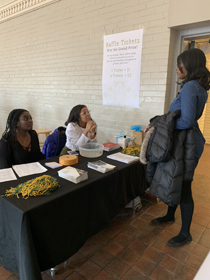 Makayla Cutter ’22 and Gaby Farmer ’22, members of ESSENCE Women of Color, greet a visitor to the expo. (Photo by Kristen Popham '20)