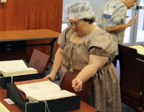 Angela Burke reads materials from the George Tucker Collection. (Photo by Jordan Williams)