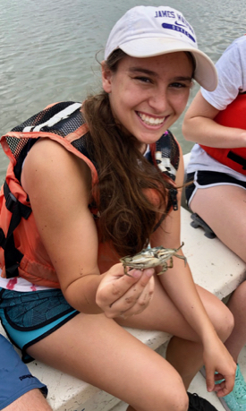 Kayla Rutherford holds a blue crab collected during the REU's annual visit to VIMS Eastern Shore Lab in Wachapreague. (Photo by R. Seitz/VIMS)