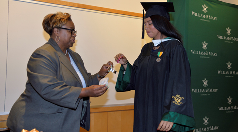 Jackie Valles '19 (right) receives a commemorative bracelet from Center for Student Diversity Director Kimberly Weatherly to honor her efforts in creating the Latinx Grad ceremony . (Photo by Jay Paul)
