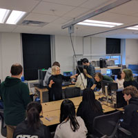 Professor Elizabeth Mead talks with students about training on the microscope in the Small Hall Makerspace. (Photo by Jonathan Frey)