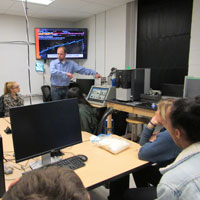 Makerspace Director Jonathan Frey explains to students how to use the microscope in the Small Hall Makerspace. (Photo by Joseph McClain)