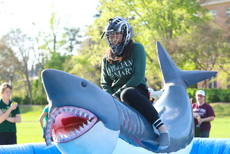 A student rides a mechanical shark during the carnival. (Photo by Alfred Herczeg)
