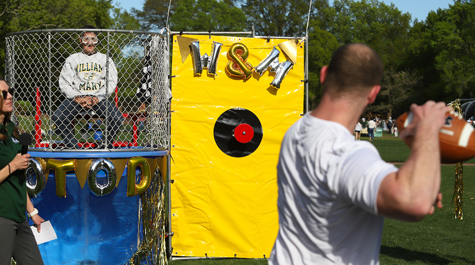 A participant in the Sunken Garden carnival tries to dunk Chancellor Professor of Biology Dan Cristol. (Photo by Alfred Herczeg)