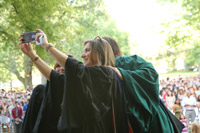 Provost Agouris snaps a selfie at Convocation